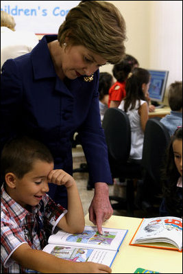 Mrs. Laura Bush reads with a child at the opening of the American Children's Corner at Sofia City Library Monday, June 11, 2007, in Sofia. Mrs. Bush said, "The books in this American Corner tell the story of the United States, describing my country's history, culture and diverse society. In these books, children in Sofia can discover literature that children in the United States enjoy."