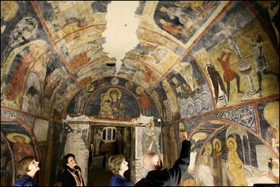 Mrs. Laura Bush listens to Mr. Belcho Belev, Senior Curator of the Boyana Church, during a tour Monday, June 11, 2007, in Sofia, Bulgaria. A total of 89 scenes with 240 human images are depicted on the walls of the church which owes its world fame mainly to its fresco paintings from 1259.