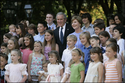 President George W. Bush and Mrs. Laura Bush pose for a photo Saturday, June 9, 2007, with children of employees and staff of the American Embassy in Rome.