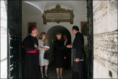 Mrs. Laura Bush shakes the hand of a Vatican official after visiting the tomb of Pope John Paul II Saturday, June 9, 2007, in Rome.