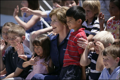 Mrs. Laura Bush sits with children of employees and staff at the U.S. Embassy Monday, in Sofia, Bulgaria, the last stop on a weeklong European visit by she and President George W. Bush.