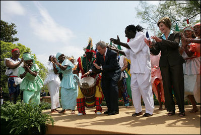President George W. Bush and Mrs. Laura Bush take the stage with the Kankouran West African Dance Company after delivering remarks during a ceremony marking Malaria Awareness Day Wednesday, April 25, 2007, in the Rose Garden.