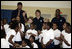 Mrs. Laura Bush, joined by NBA and WNBA players, prepares to pose for photos with fifth-grade students following a basketball game during a Malaria Awareness Day event Wednesday, April 25, 2007, at the Friendship Public Charter School on the Woodridge Elementary and Middle School campus in Washington, D.C.