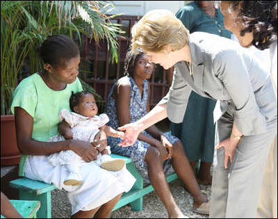 Mrs. Laura Bush is introduced to a participant and her infant daughter at the GHESKIO HIV/AIDS Center’s women’s clinic, Thursday, March 13, 2008, in Port-au-Prince, Haiti. The program was initiated to help improve the lives of HIV patients.