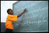 A student at the IDEJEN educational program reads from a chalkboard Thursday March, 13, 2008, during Mrs. Laura Bush's visit to the program at the College de St. Martin Tours in Port-au-Prince, Haiti.