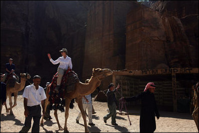 Mrs. Laura Bush takes a ride on a camel while touring Petra, an ancient city in southern Jordan Friday, Oct. 26, 2007. In 1997, a carved relief depicting two pairs of camels and camel drivers were discovered at the entrance of the city. During its time, Petra was a caravan city and trading center for the entire region.