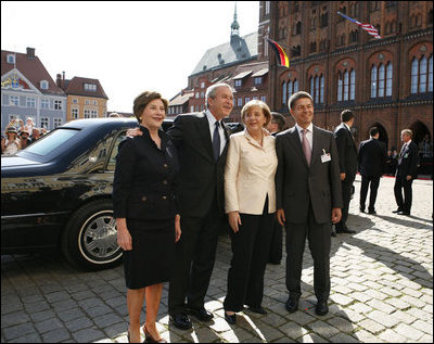 President George W. Bush and Laura Bush participate in an arrival ceremony with German Chancellor Angela Merkel and her husband Joachim Sauer in Stralsund, Germany, Thursday, July 13, 2006.