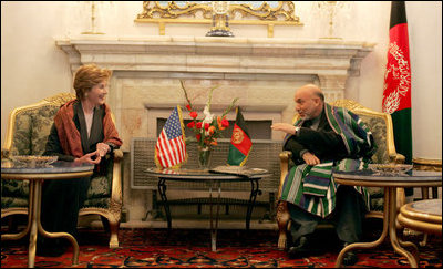 Afghan President Hamid Karzai jokes with Laura Bush during a meeting in the Presidential Palace in Kabul, Afghanistan, Wednesday, March 30, 2005. 