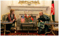 Afghan President Hamid Karzai jokes with Laura Bush during a meeting in the Presidential Palace in Kabul, Afghanistan, Wednesday, March 30, 2005. 