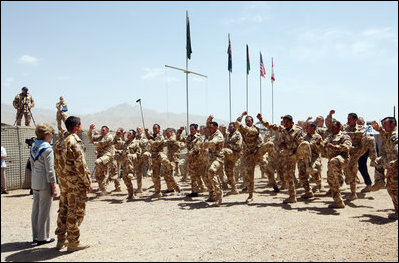 Mrs. Laura Bush is greeted Sunday, June 8, 2008, by New Zealand troops performing a traditional warrior's dance at the Bamiyan Provincial Reconstruction Team Base in Afghanistan's Bamiyan province. Standing with her is Major Justin de la Haye.