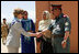 Governor Habiba Sarabi, center, introduces Mrs. Laura Bush to Col. Hafizullah Paymon, Commander of the Afghan Regional Training Center, during a visit to the Police Training Academy in Bamiyan, Afghanistan there Sunday, June 8, 2008.