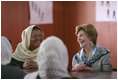 Mrs. Laura Bush smiles as she meets Sunday, June 8, 2008, with female graduates of the Police Training Academy in Bamiyan province in Afghanistan. With her is Bamiyan Governor Habiba Sarabi.