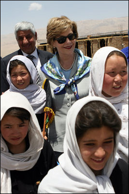 Mrs. Laura Bush is joined by Ihsan Ullah Bayat, top let, and young Afghan girls during a tour of the construction site of the Ayenda Learning Center Sunday, June 8, 2008, in Bamiyan, Afghanistan.