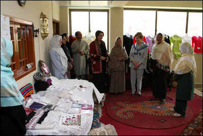 Mrs. Laura Bush speaks with Afghan women entrepreneurs during her visit to the marketplace of Arzu and Bamiyan Women's Business Association Sunday, June 8, 2008, in Afghanistan.
