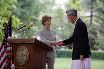 Mrs. Laura Bush shakes hands with President Hamid Karzai of Afghanistan, Sunday, June 8, 2008, during their press availability at the presidential palace in Kabul.