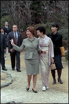 Mrs. Bush waves to members of the media and onlookers as she walks with Kiyoko Fukuda following a lunch and tea ceremony at Akasaka Palace Monday, February 18, 2002 in Tokyo. 
