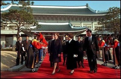 Mrs. Bush walks with the First Lady of the Republic of Korea Madame Lee Hee-ho in the Grand Garden of Chong Wa Dae (Blue House) during official arrival ceremonies in Seoul Wednesday, February 20, 2002.