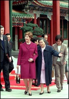 Mrs. Bush and Madame Wang, wife of Chinese President Jiang Zemin, walk from a welcoming tea ceremony at Yuan Dian Hall to lunch in the Xiang Yi Dian Hall in the Zhongnanhai compound Friday, February 22, 2002 in Beijing.