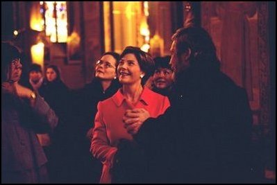 Laura Bush, joined by Debbie Stapleton, wife of U.S. Ambassador to the Czech Republic, left, and Press Secretary Noelia Rodriguez, right, listens to a tour of Vysehrad Church of Saints Peter and Paul in Prague, Czech Republic Thursday, Nov. 21, 2002.