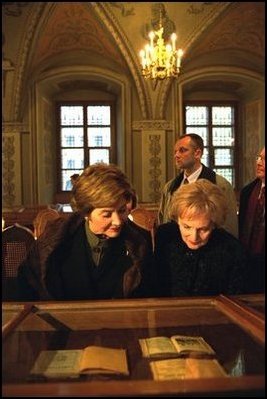 Laura Bush looks over the historic book collection housed at Vilnius University with Alma Adamkiene, wife of the President of Lithuania, Saturday, Nov. 23, 2002.