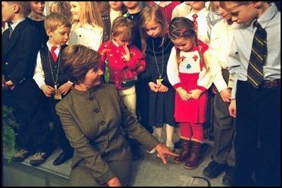Laura Bush jokes with some children of embassy employees at the American Center in Vilnius, Lithuania Saturday, November 23, 2002.