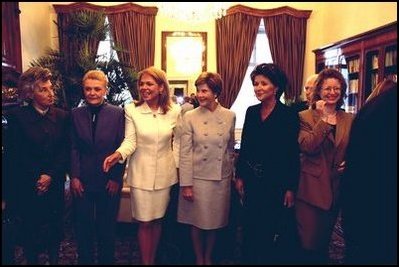 Laura Bush stands between the First Lady of Poland Jolenta Kwasneiska, third right, and First Lady of the Czech Republic , Dagmar Havlova, third left, as other spouses to NATO heads of state line up for a photo-op prior to a luncheon hosted by Dagmar Havlova at a Presidential retreat outside Prague. 