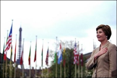Laura Bush stands with her hand over her heart as the U.S. flag is raised in front of UNESCO headquarters Sept. 9, 2003, in Paris to mark the re-joining of the United States to the international organization. Mrs. Bush is the Goodwill Ambassador for the UNESCO Decade of Literacy.