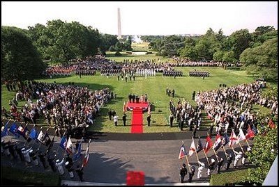 President George W. Bush and Laura Bush stand with visiting President Aleksander Kwasniewski of Poland and his wife, Jolanta Kwasniewska, during the State Arrival Ceremony on the South Lawn Wednesday, July 17, 2002.