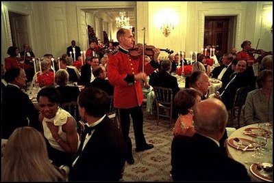 As White House staff and Cabinet members dine with invited guests, members of the Marine Band perform throughout the State Dining Room July 17.