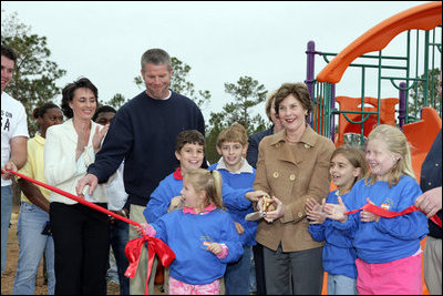 Laura Bush attends a ribbon cutting ceremony with football star Brett Favre and his wife, Deanna, left, at the Kaboom Playground, built at the Hancock North Central Elementary School in Kiln, Ms., Wednesday, Jan. 26, 2006, during a visit to the area ravaged by Hurricane Katrina.