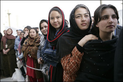 Women stand outside the U.S. Embassy in Kabul, Afghanistan Wednesday, March 1, 2006. President George W. Bush and Laura Bush made a surprise visit to the city and presided over a ceremonial ribbon-cutting at the embassy before continuing their trip to India.