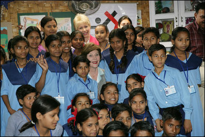 Mrs. Laura Bush poses for photos with teachers and students on her tour of Prayas, Thursday, March 2, 2006, in New Delhi, India.