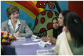 Mrs. Laura Bush listens to a young woman during an informal group discussion with teachers and students on her tour of Prayas, Thursday, March 2, 2006, in New Delhi, India.
