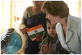 Mrs. Laura Bush watches as a child points out a place on a globe, Thursday, March 2, 2006, during her visit to Mother Teresa's Jeevan Jyoti (Light of Life) Home for Disabled Children in New Delhi, India.