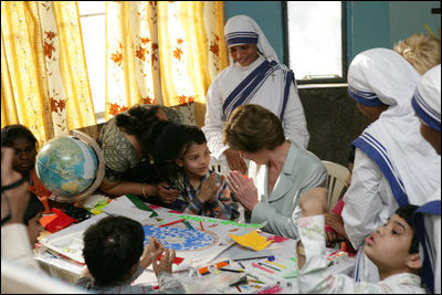 Mrs. Laura Bush is introduced to a young child, Thursday, March 2, 2006, during her visit to Mother Teresa's Jeevan Jyoti (Light of Life) Home for Disabled Children in New Delhi, India.