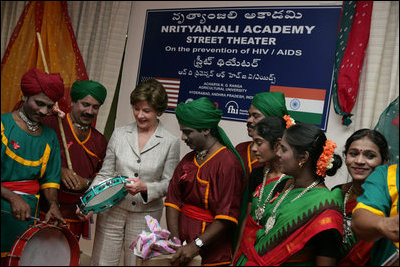 Mrs. Laura Bush plays a tambourine presented to her by the Nrityanjali Academy performers Friday, March 3, 2006 during her participation in an HIV/AIDS prevention event in Hyderabad, India.