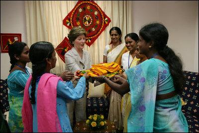 Mrs. Laura Bush is presented with gifts on her visit to an HIV/AIDS education prevention and treatment facility, Friday, March 3, 2006 at the Acharya N.G. Ranga Agricultural University in Hyderabad, India.