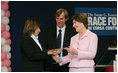 Mrs. Laura Bush presents the first Komen Italia Award, Thursday, Feb. 9, 2006 to Mrs. Marisa Giannini, a cancer survivor and the director of the Philatelic division of the Italian Postal Service, for her volunteer services with Koman Italia of The Susan G. Komen Breast Cancer Foundation.