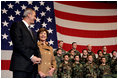 Laura Bush stands with U.S Ambassador to Italy Ron Spogli before speaking with troops during a visit to Aviano Air Base, in Aviano, Italy, Friday, Feb. 10, 2006.