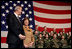 Laura Bush stands with U.S Ambassador to Italy Ron Spogli before speaking with troops during a visit to Aviano Air Base, in Aviano, Italy, Friday, Feb. 10, 2006.