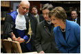 Laura Bush looks at an Ancient Thesis of Montichelli during a tour given by Paolo Novaria, Archives, left, at the University of Turin Saturday, Feb. 11, 2006, in Turin, Italy.