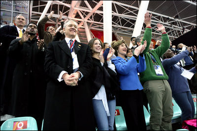 Laura Bush, her daughter, Barbara, and members of the U.S. Olympic Delegation, cheer on American Speed Skater Chad Hedrick Saturday, Feb. 11, 2006, during his heat at the 2006 U.S. Winter Olympics, in Turin, Italy. Hedrick went on to win the first gold medal for the United States.