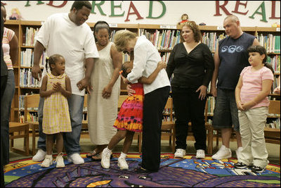 Laura Bush embraces a child Thursday, Sept. 8, 2005 of one of the families from New Orleans, displaced last week as a result of Hurricane Katrina,  during a meeting at the Greenbrook Elementary School in DeSoto County, Miss.  Greenbrook Elementary School has enrolled the most displaced students among the DeSoto County schools in Mississippi.