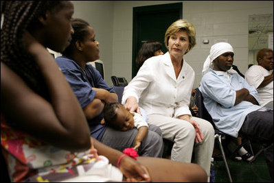 Laura Bush visits with people affected by Hurricane Katrina in the Cajundome at the University of Louisiana in Lafayette, La., Friday, Sept. 2, 2005.