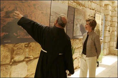 Father Michele Piccirillo, head of the Franciscan Archeology Society, gives Laura Bush a tour of the Interpretative Center at Mount Nebo in Jordan Saturday, May 21, 2005. Mount Nebo is the holy site where Moses is believed to have died.
