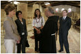 Laura Bush talks with Father Michele Piccirillo, head of the Franciscan Archeology Society, Chief of Staff Anita McBride, second on left, and Queen Rania al-Abdullah, center, in the Basillica on top of Mount Nebo in Jordan Saturday, May 21, 2005.