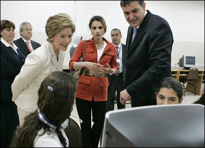 Laura Bush and Queen Raina Al-Abdullah, wife of King Abdullah of Jordan, center, talk with students during a computer lab at the Discovery School of Swaifiyeh Secondary School in Amman, Jordan, Sunday, May 22, 2005.