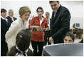 Laura Bush and Queen Raina Al-Abdullah, wife of King Abdullah of Jordan, center, talk with students during a computer lab at the Discovery School of Swaifiyeh Secondary School in Amman, Jordan, Sunday, May 22, 2005.