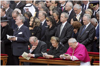 President George W. Bush and Laura Bush stand amidst mourners at funeral services Friday, April 8, 2005, for the late Pope John Paul II in St. Peter's Square.