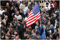An American flag flies high above the throng of mourners inside St. Peter's Square Friday, April 8, 2005, as thousands attend funeral mass for Pope John Paul II, who died April 2 at the age of 84.